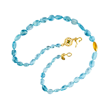 Load image into Gallery viewer, Santa Maria aquamarine is the most coveted of all the aquamarine hues - it has an unrivalled intensity of color. A single brushed gold Mesopotamian style hollow bead is a perfect foil, sand and sea. An intricate Roman style filigree decorated clasp, gem
set on each side, completes the necklace. Length 19 inches. 

Made from recycled 22k gold, unheated Brazilian Santa Maria aquamarine (126.53ctw), Brazilian Paraiba tourmaline (.05ctw) and Burmese pink spinel ((,07ctw). One-of-a-kind.