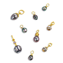 Load image into Gallery viewer, The Maki-e pearl charm with Anthill garnets (middle row, on the right) shown with other Maki-e and Tahitian pearl charms.