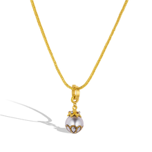 Load image into Gallery viewer, The Maki-e pearl with Anthill garnets charm shown on a handwoven gold chain.