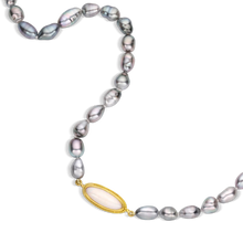 Load image into Gallery viewer, Gorgeous oval shaped ombré Tahitian Keshi pearls graduating in color from silver through deep gray with pink overtones combine in this glossy pearl strand fastened with a granulated toggle clasp. A bezel set oval white Australian opal (2.55ct) with flashes of orange and green is offset in the strand giving a contemporary touch. Length 19.5 inches.

Made with recycled 22k yellow gold and 6-7mm Tahitian Keshi pearls. Knotted on silk.