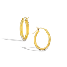 Load image into Gallery viewer, Graduated granulation in gold and platinum has become one of our signatures. The rich, warm tones of the high karat gold and polished platinum lend both a classic and contemporary feel, the granulation that ooh! factor. Ideal for everyday wear by themselves, pair with a charm to move into dressier occasions. Diameter approximately 19.8mm, W 2.6mm (D .8in W .1in).

Made from recycled 22k yellow gold and platinum.