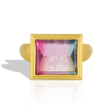 Load image into Gallery viewer, A stunning custom cut bi-color tourmaline graduating from hot pink through to bright blue, this beautiful rectangular lozenge shape gem has a glittering, reflective surface.  The buttery tones of the gold soften the bold, angular and contemporary lines of the cut, seamlessly blending the ancient lattice style with today's aesthetic.

Made from recycled 22k gold and a bi-color tourmaline (5.81ct) from Itambacurí, Brazil. Size 7. Can be resized.