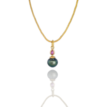 Load image into Gallery viewer, One of our Perfumer's Flask series. A sensuously rounded, flask shaped and beautifully lustrous deep blue circlé pearl has a dainty Arabian Nights style ruby "stopper" atop a flower shaped cap - all in polished 22k yellow gold. A moveable granulated pear-shaped bail completes this one-of-a-kind charm. Length approx. 28mm, width 10.5mm (L 1.1in W .4in). Made from recycled 22k gold, a 10.6x11mm cultured Tahitian pearl and Thai ruby (.19ctw). The chain is available separately.