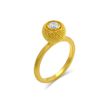 Load image into Gallery viewer, Inspired by the goldsmiths of antiquity, who used gold granules to paint scenes and tableaux on their work, this elegant and versatile ring has the silky appearance of a soft, rounded velvet cushion. The gold is smooth and almost soft to the touch, and a discreet diamond sparkle make it a perfect choice for frequent wear. A parchment like texture gives the ring band a soft parchment like feel.

Made in recycled 22k yellow gold an antique diamond (F-G VS, .25ctw). Size 7. Can be resized.