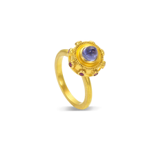 Load image into Gallery viewer, Reminiscent of a bejeweled Orb, instead of a customary cross mounted top it, this one has a soft violet blue tanzanite cut in a bullet style cabochon. A band of delicious purplish Anthill garnets and golden balls of granulation floats around it like miniature moons.

Made in recycled 22k yellow gold, responsibly sourced tanzanite (.93ctw) and garnets (.15cyw). Size 6.5. Made to order.